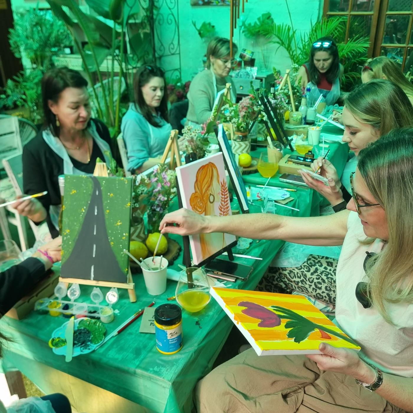 Guests relaxed and absorbed in painting during the Women's Day Sip & Paint experience